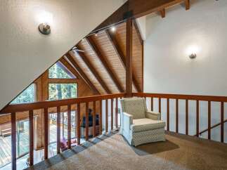 Experience the charm of this rustic loft with its stunning A-frame architecture and exposed wooden beams.
