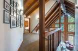 Ascend to a lofted haven featuring a stunning vaulted ceiling with exposed wooden beams, creating an airy and rustic ambiance.