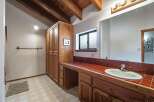 This charming bathroom features a spacious vanity with a tiled countertop and ample storage, perfect for organizing your essentials.