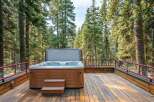 Experience ultimate relaxation in this secluded hot tub, nestled amongst towering pine trees.