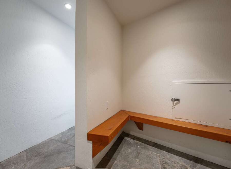This inviting space features a built-in wooden bench, perfect for a mudroom or entryway.