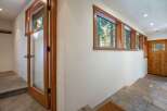 Step into this charming entryway featuring a beautiful wooden door with glass panes, inviting natural light into the space.