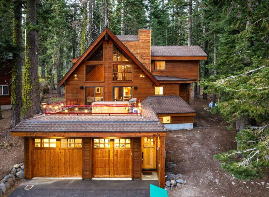 Nestled amidst towering pine trees, this stunning wooden A-frame cabin offers a luxurious mountain retreat.