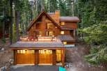 Nestled amidst towering pine trees, this stunning wooden A-frame cabin offers a luxurious mountain retreat.