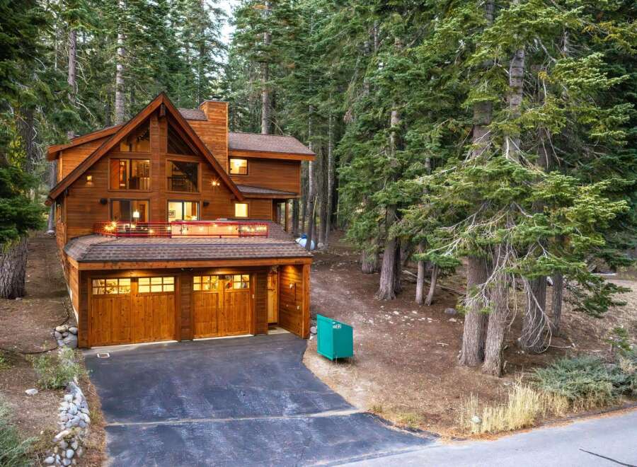 Nestled amidst towering pine trees, this stunning wooden mountain home offers a serene retreat.