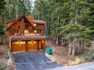 Nestled amidst towering pine trees, this stunning wooden mountain home offers a serene retreat.