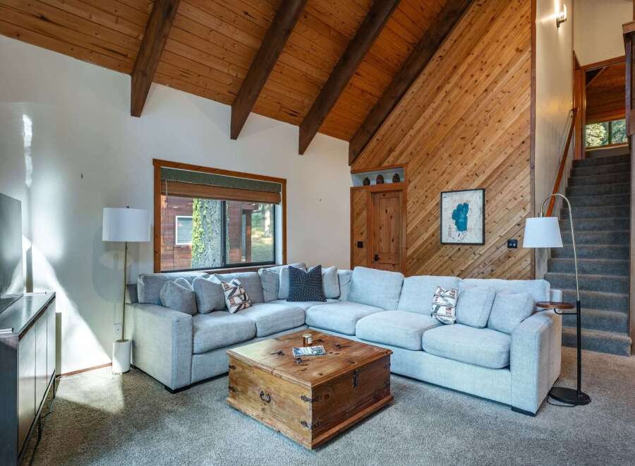 Experience rustic charm in this inviting living room, featuring a spacious sectional sofa perfect for gatherings.
