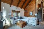Experience rustic charm in this inviting living room, featuring a spacious sectional sofa perfect for gatherings.