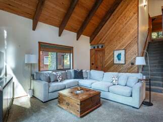 Experience rustic charm in this inviting living room, featuring a spacious sectional sofa perfect for gatherings.