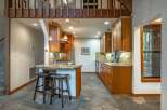 This charming kitchen boasts warm wooden cabinetry and granite countertops, creating a cozy and inviting atmosphere.