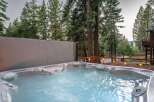 Indulge in ultimate relaxation in this luxurious hot tub, perfectly situated amidst a serene forest setting.