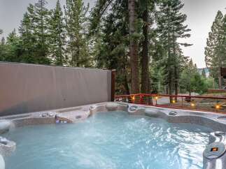 Indulge in ultimate relaxation in this luxurious hot tub, perfectly situated amidst a serene forest setting.