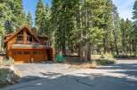 Nestled amidst towering pine trees, this stunning wooden A-frame home offers a serene mountain retreat.