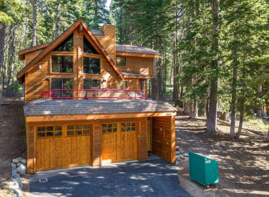 Nestled amidst towering pine trees, this stunning wooden mountain home offers a serene retreat.