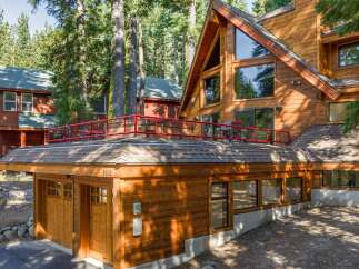 Experience rustic charm and modern comfort in this stunning wooden A-frame home nestled among tall pine trees.