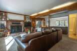 Cozy living room featuring a large brick fireplace and built-in bookshelves, perfect for relaxing evenings.