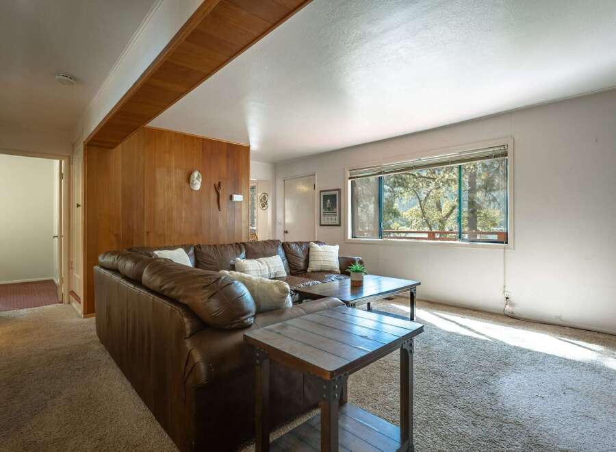Step into this inviting living room featuring a plush brown leather sectional sofa, perfect for cozy gatherings.