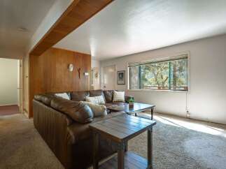 Step into this inviting living room featuring a plush brown leather sectional sofa, perfect for cozy gatherings.