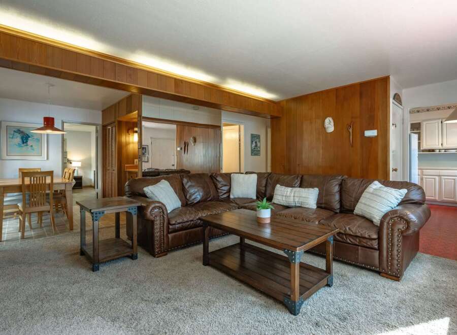 This spacious living area features a large, comfortable sectional sofa perfect for family gatherings.