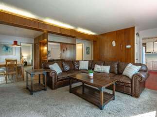 This spacious living area features a large, comfortable sectional sofa perfect for family gatherings.