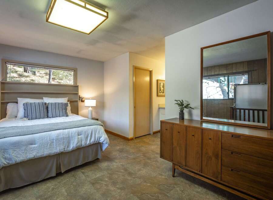 This charming bedroom features a comfortable queen-size bed with plush bedding and decorative pillows, perfect for a restful night's sleep.