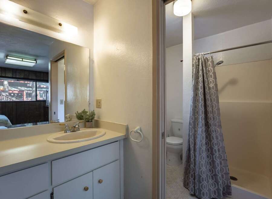 This bathroom features a spacious vanity with ample counter space and storage, perfect for organizing your essentials.
