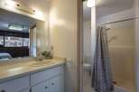 This bathroom features a spacious vanity with ample counter space and storage, perfect for organizing your essentials.