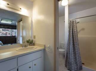 This bathroom features a spacious vanity with ample counter space and storage, perfect for organizing your essentials.