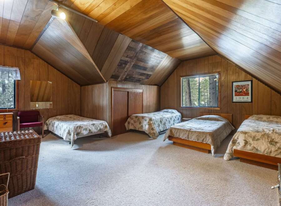 This charming attic bedroom features multiple beds, perfect for accommodating family and friends.