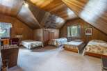 This charming attic bedroom features multiple beds, perfect for accommodating family and friends.