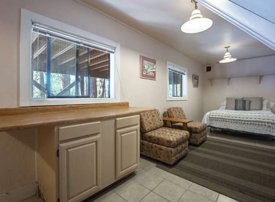 This charming space features a convenient kitchenette area with ample counter space and cabinetry, perfect for preparing light meals.