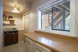 Discover a charming kitchen space featuring a functional sink and ample countertop area, perfect for meal preparation.