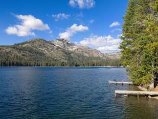 Experience serene lakefront living with this stunning property, featuring private docks perfect for your boat or morning coffee.