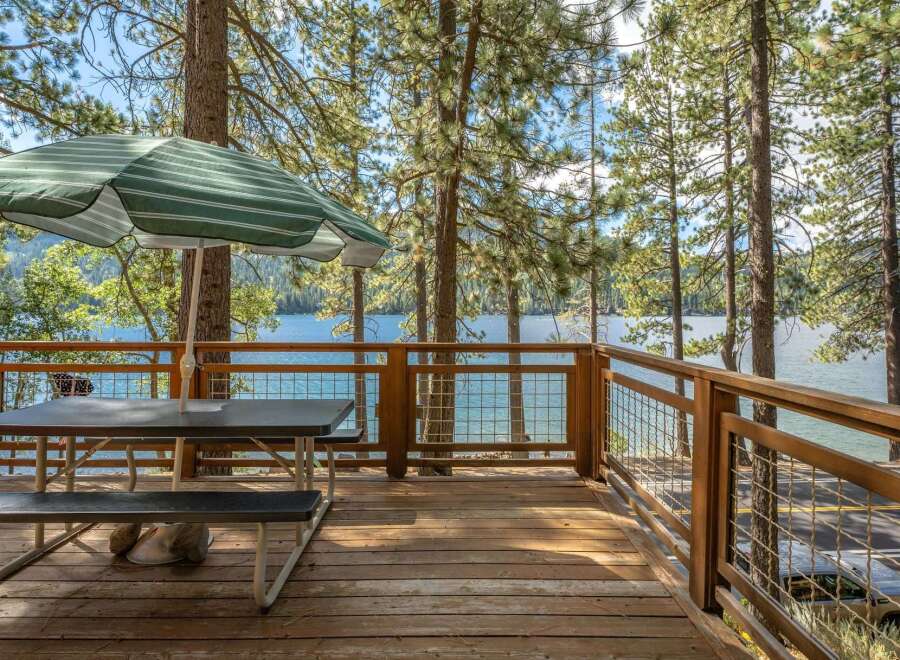 Enjoy breathtaking lake views from this spacious deck, perfect for outdoor dining and relaxation.
