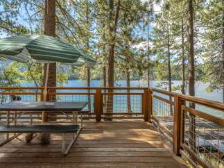 Enjoy breathtaking lake views from this spacious deck, perfect for outdoor dining and relaxation.