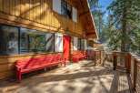 Experience lakeside living in this charming wooden cabin, featuring a spacious deck perfect for enjoying the serene water views.