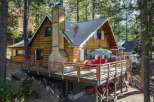Nestled amongst tall pine trees, this charming wooden cabin offers a serene mountain retreat.