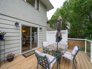 Enjoy outdoor living on this spacious wooden deck, perfect for entertaining or relaxing.