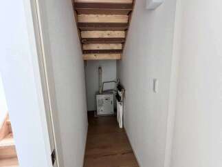 Discover the practical side of this home with its cleverly designed under-stair storage space, perfect for maximizing utility.