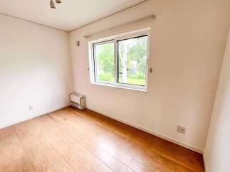 This bright and airy room features a large window offering scenic views of the outdoors.