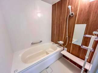 Experience modern comfort in this bathroom featuring a sleek bathtub and a stylish showerhead.