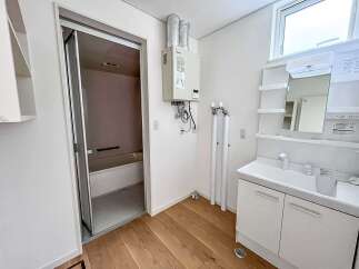Discover modern living in this well-appointed bathroom featuring a sleek vanity with ample storage and a bright, spacious shower area.