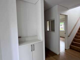 Step into this modern home featuring a sleek white built-in cabinet and a bright, open-concept living space.