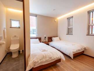 This hotel room offers a comfortable stay with two twin beds, perfect for solo travelers or friends.