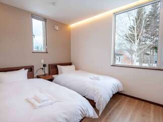 Experience comfort and style in this beautifully appointed bedroom featuring two twin beds, perfect for accommodating guests or family.
