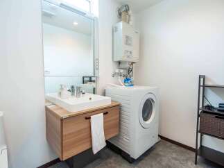 This modern bathroom features a sleek vanity with a white vessel sink and a large mirror, perfect for your morning routine.