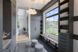 Discover modern living in this spacious entryway, featuring sleek grey cabinetry and ample storage solutions.