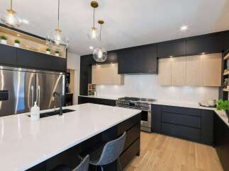 Experience modern luxury in this stunning kitchen, featuring sleek black cabinetry contrasted with warm wood accents.