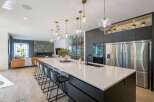 Experience modern luxury in this stunning open-concept kitchen and living area.