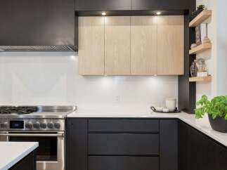 Experience modern luxury in this stunning kitchen, featuring sleek black cabinetry contrasted with warm, natural wood upper cabinets.